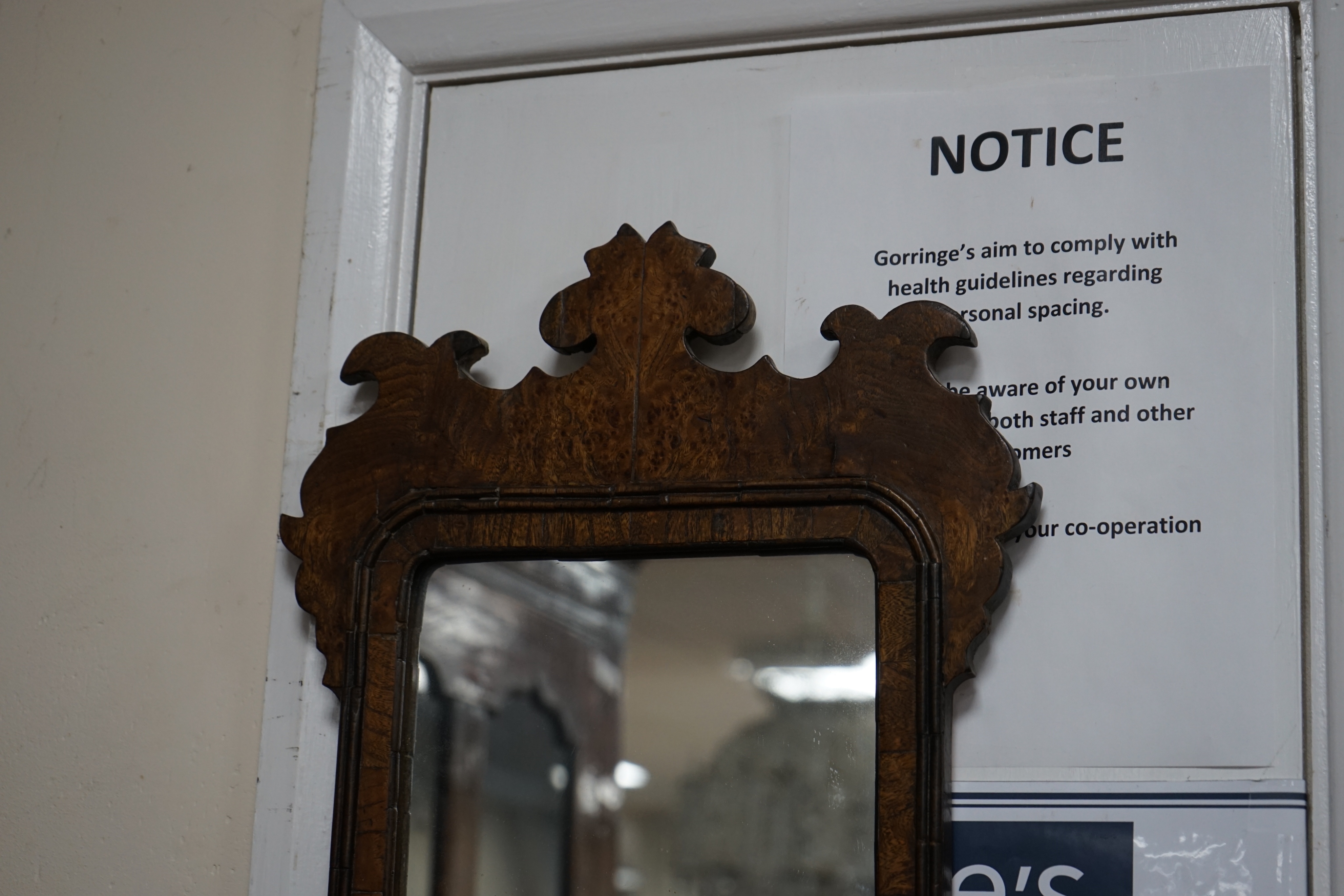 A small burr oak veneered fret cut wall mirror, width 34cm height 53cm